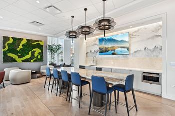 a dining room with a marble table and blue chairs  at Cassidy on Canal, Chicago